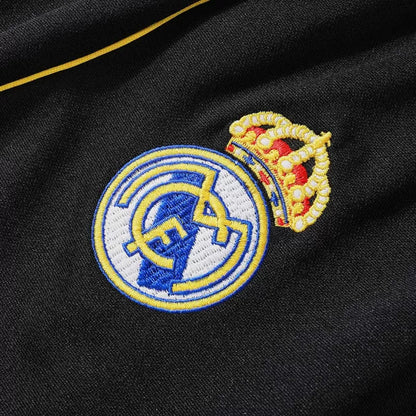 Tuta Real Madrid con zip 1/4 (giacca+pantaloni) 2025/26 - Nera